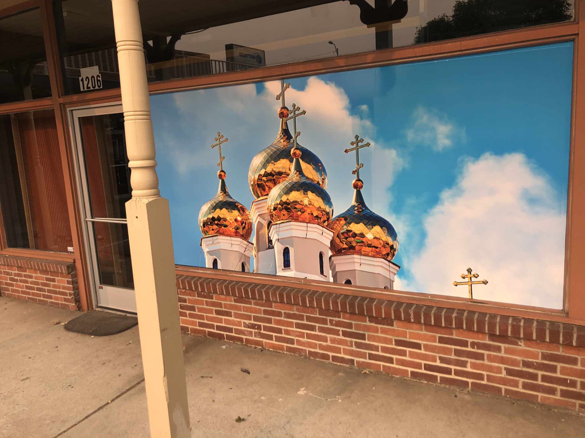 window in front of Church on Carson Street depicting Orthodox Church towers