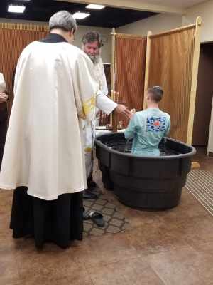 authenticity Father John baptizing young man